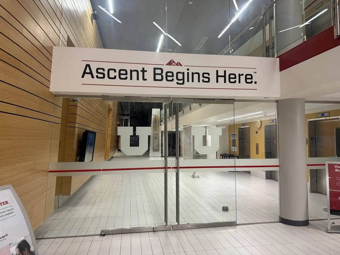 Ascent Begins Here slogan printed on a wall