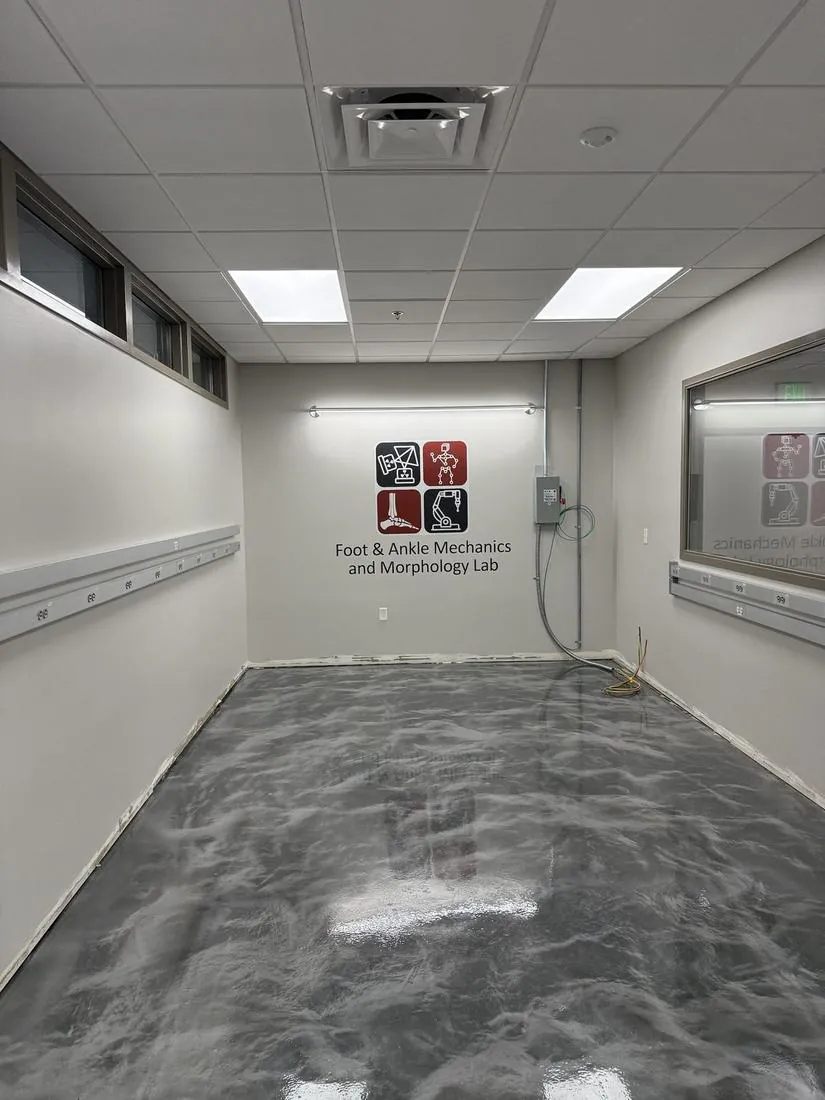 Foot and Ankle Mechanics and Morphology Lab logo printed on a wall